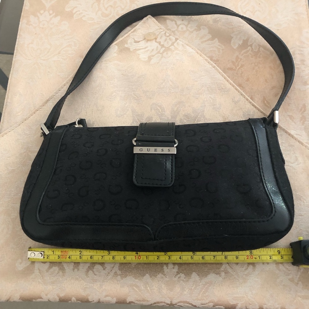 Small black Guess hand bag. Barely Used good condition.